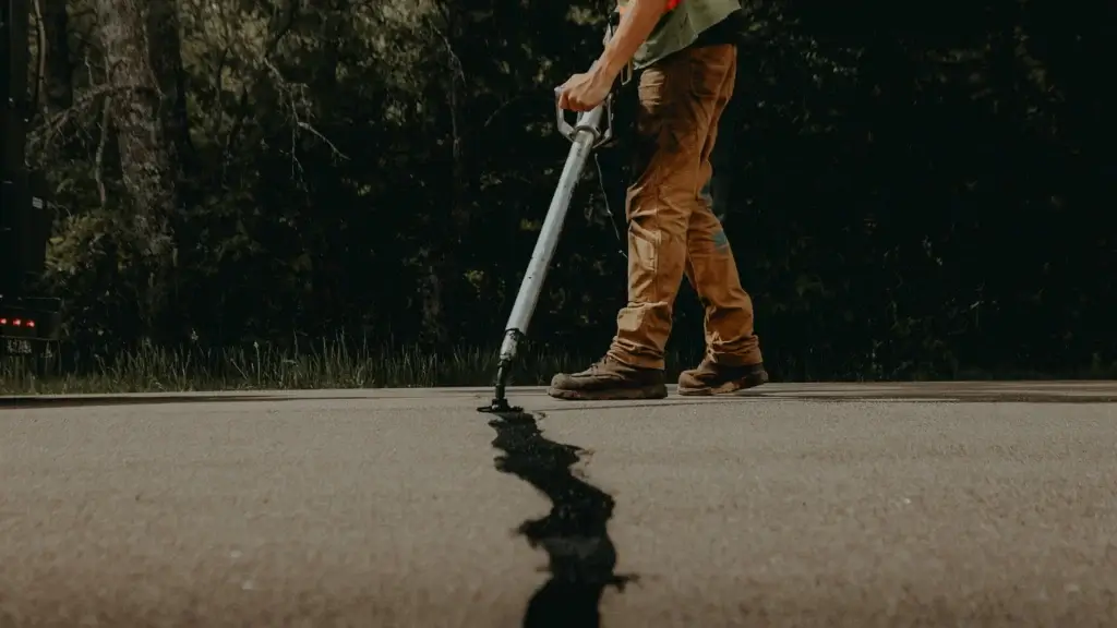Crack fill repair process hero image showing asphalt crack sealing service provided by Scott Construction.